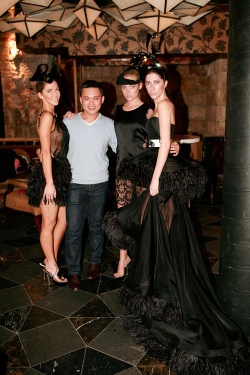 Full length shot of three models in George Wu designs and the designer standing with them.
