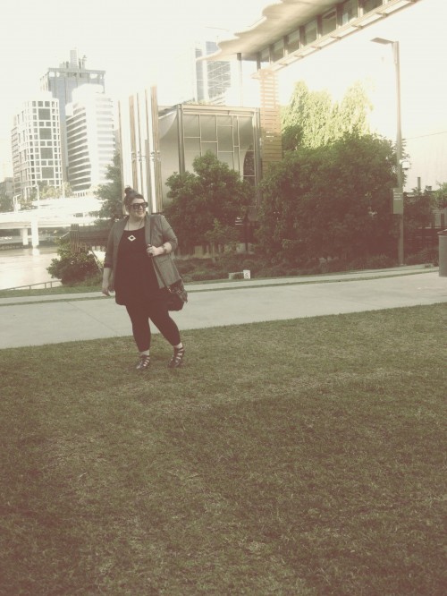 An overly edited photograph of Natalie on the GoMA Brisbane lawn, the river and CBD in the background.