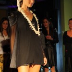 Model wearing a black and grey dress with a necklace that looks like vertibrae!