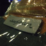 Close up of the Subfusco label sewn into a see-through plastic jacket.