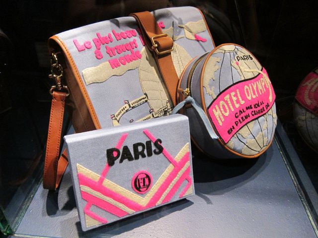 A photo of a collection of felt book covers and bags in fluoro pink, grey and cream. They have an art deco flair.