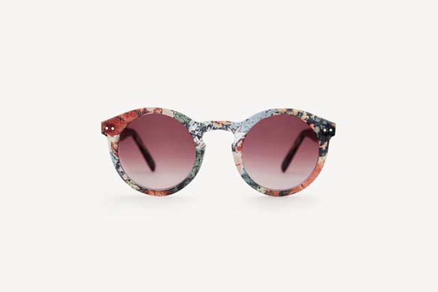 A pair of round sunglasses with floral frames and burgundy graduated frames.