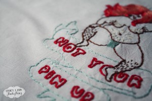 Detail of my finished version of the Not Your Pin Up embroidery pattern.