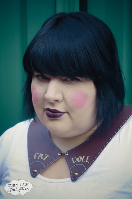 Burgundy vinyl collar embellished with hand stitched "Fat Doll" and studs.