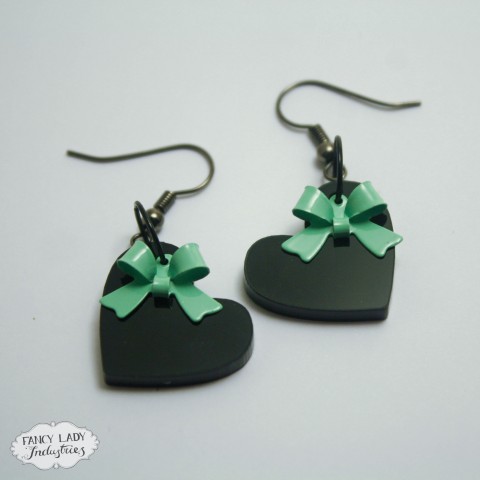 Sweet Heart earrings - Black acrylic hearts with mint bow charms dangle from hook earrings. Also available in frosted purple and assorted colour bows.