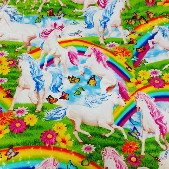 This fabric is a guide to better living. Unicorns with pink and blue manes, rainbows, butterflies, flowers and the odd sparkle.