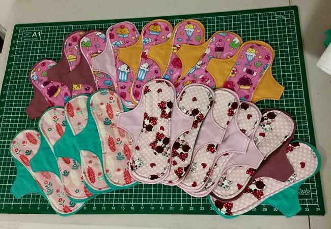 The eighteen exposed core cloth pads I made this weekend. They feature flannelette tops with lollies and sweets, dogs with sunglasses, and sweet little fern prints.