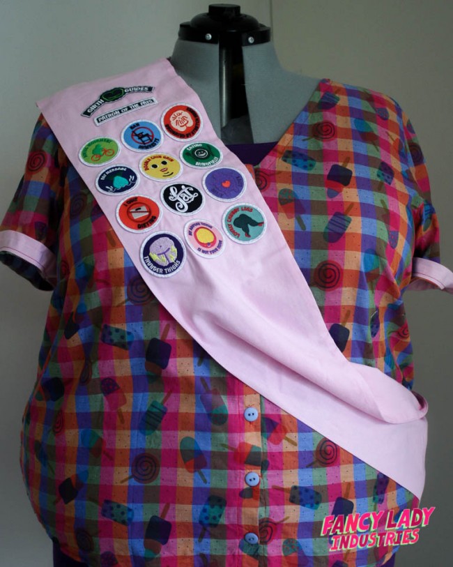 My personal pink collector's sash modelled by my dress form. The whole collection of Girth Guides patches have been sewn on.