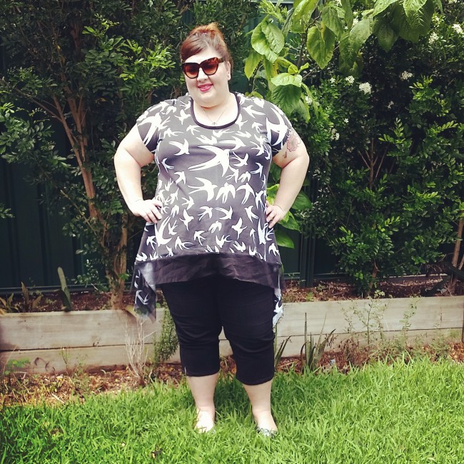 In my backyard (the trees are huge now!) wearing my black and white swallow t-shirt with some black cropped pants. 
