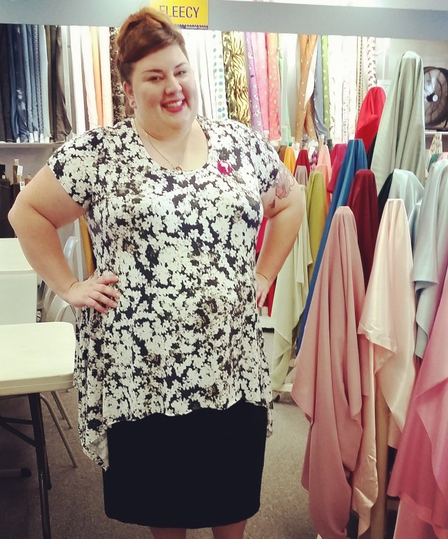 My boss took this photo of me at work, hence the lovely bolts of fabric! I'm wearing the jasmine print t-shirt here, and forcing myself to smile through the streams of constant snot!!